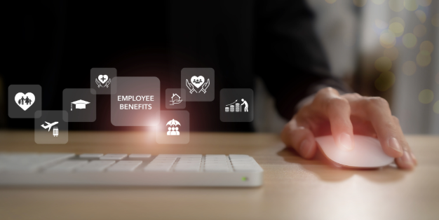 A laptop with text on the screen that reads employee benefits