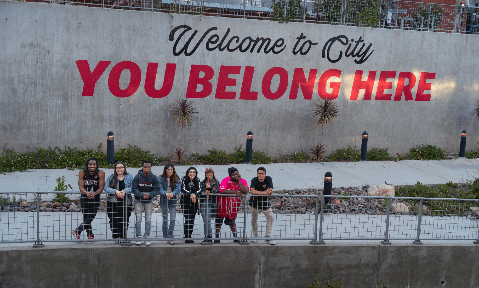 Students standing in front of You Belong Here sign on the City College campus