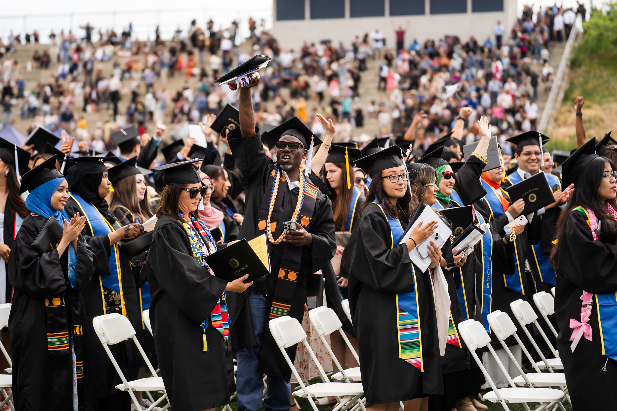 Students in their seats at commencement after receiving their diplomas