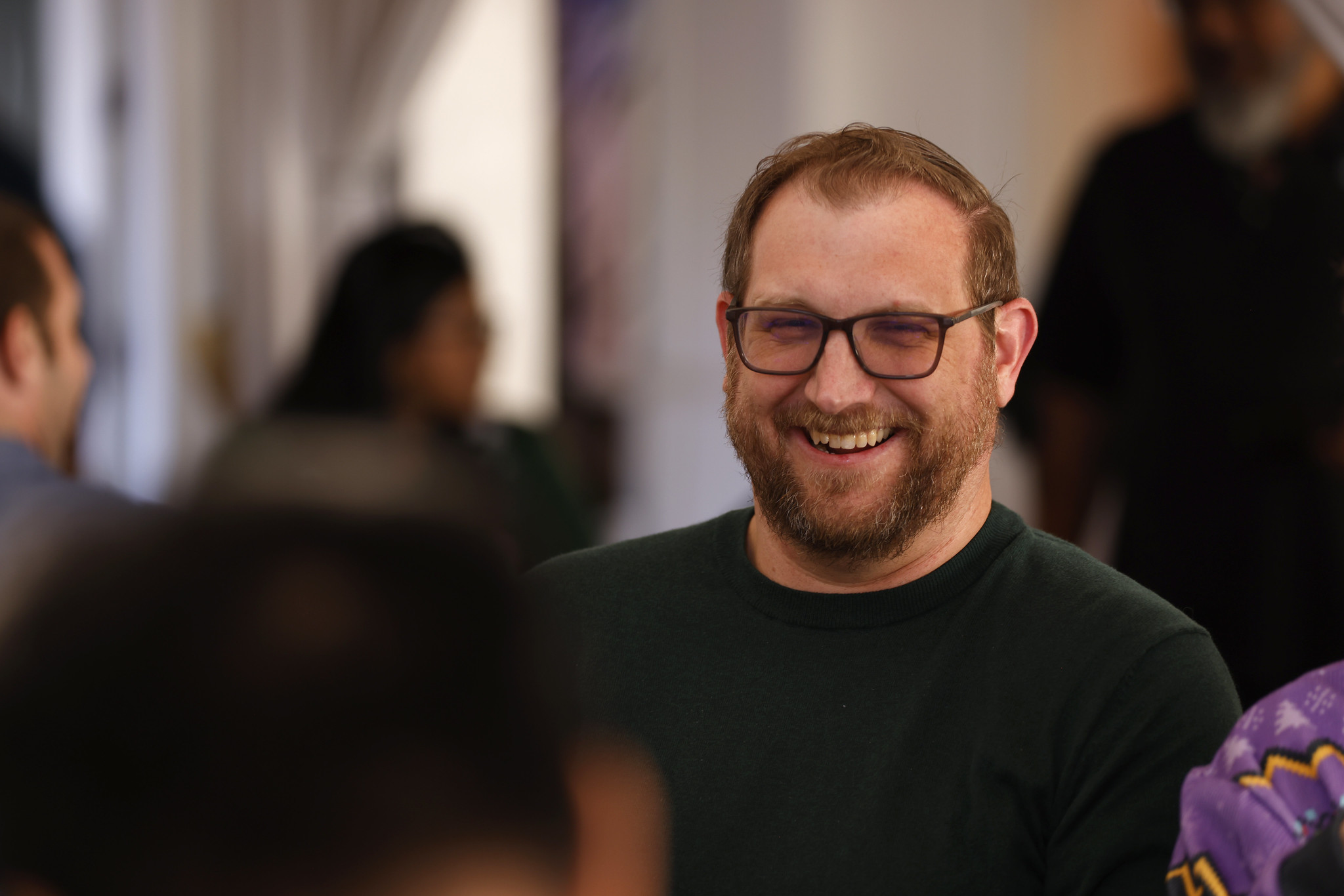 An employee smiling at a district event