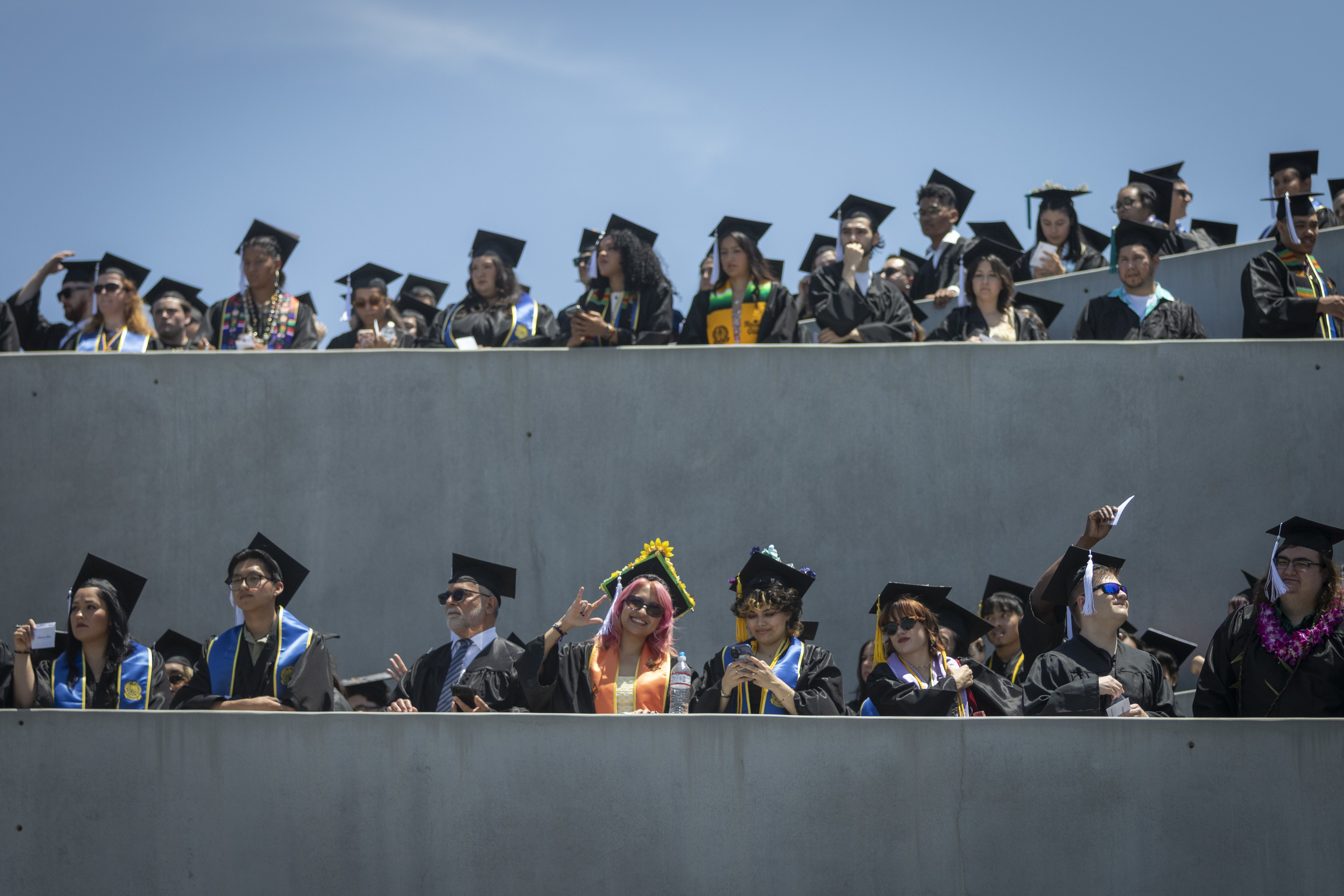 Two rows or graduates line up on the ramp at Mesa College to enter the commencement ceremony