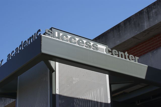 A silver sign for the success center