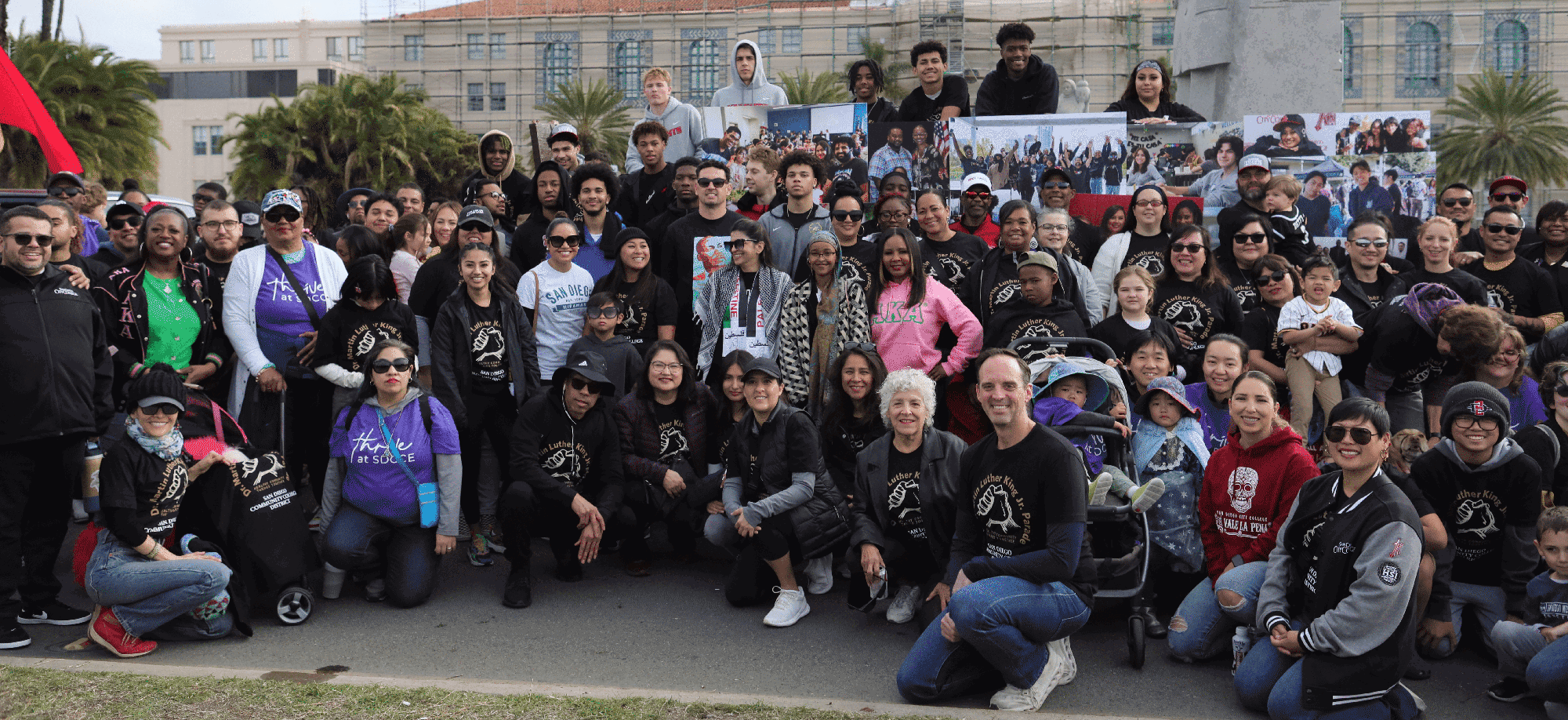 About 50 employees and students take a group photo at the MLK Parade