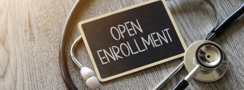 A stethoscope and a sign that say open enrollment