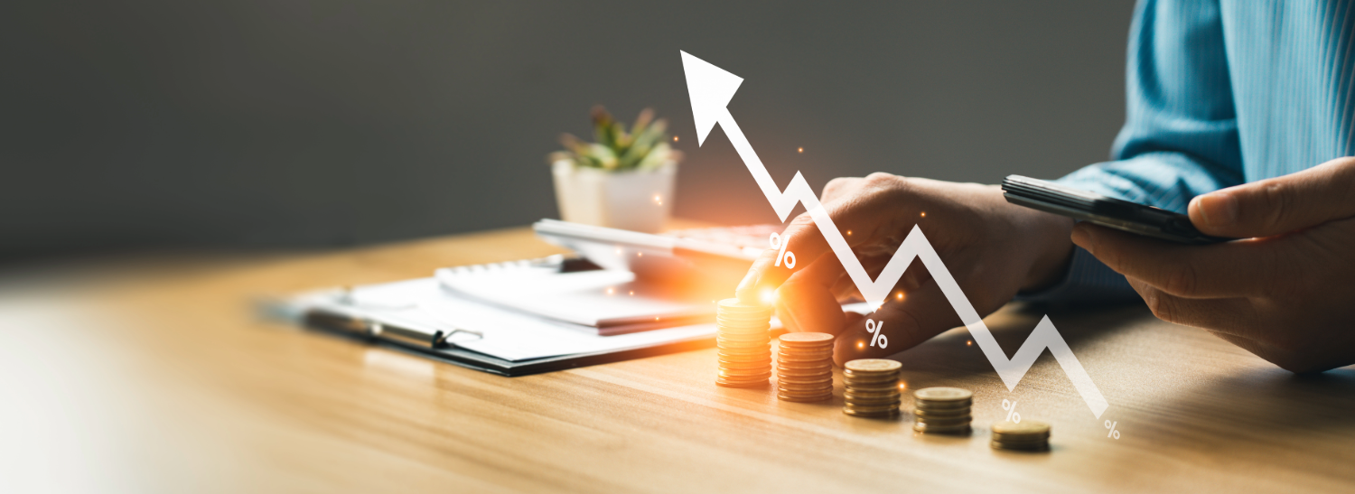 A desk shows a folder and five stacks of coins and a hand counting the coins.