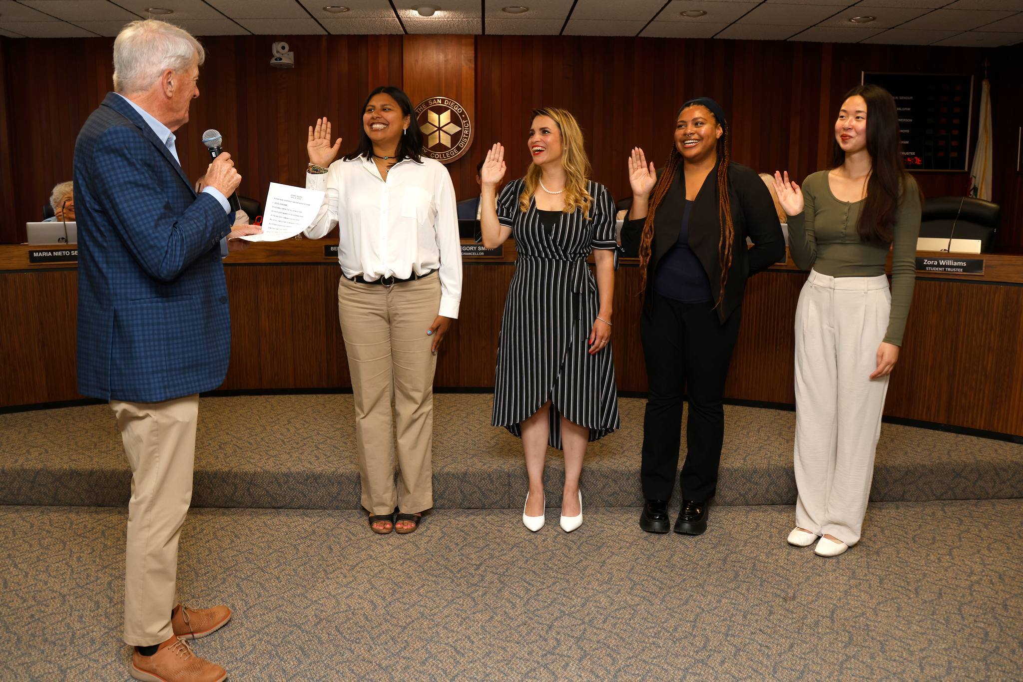 Board President swearing in four student trustees