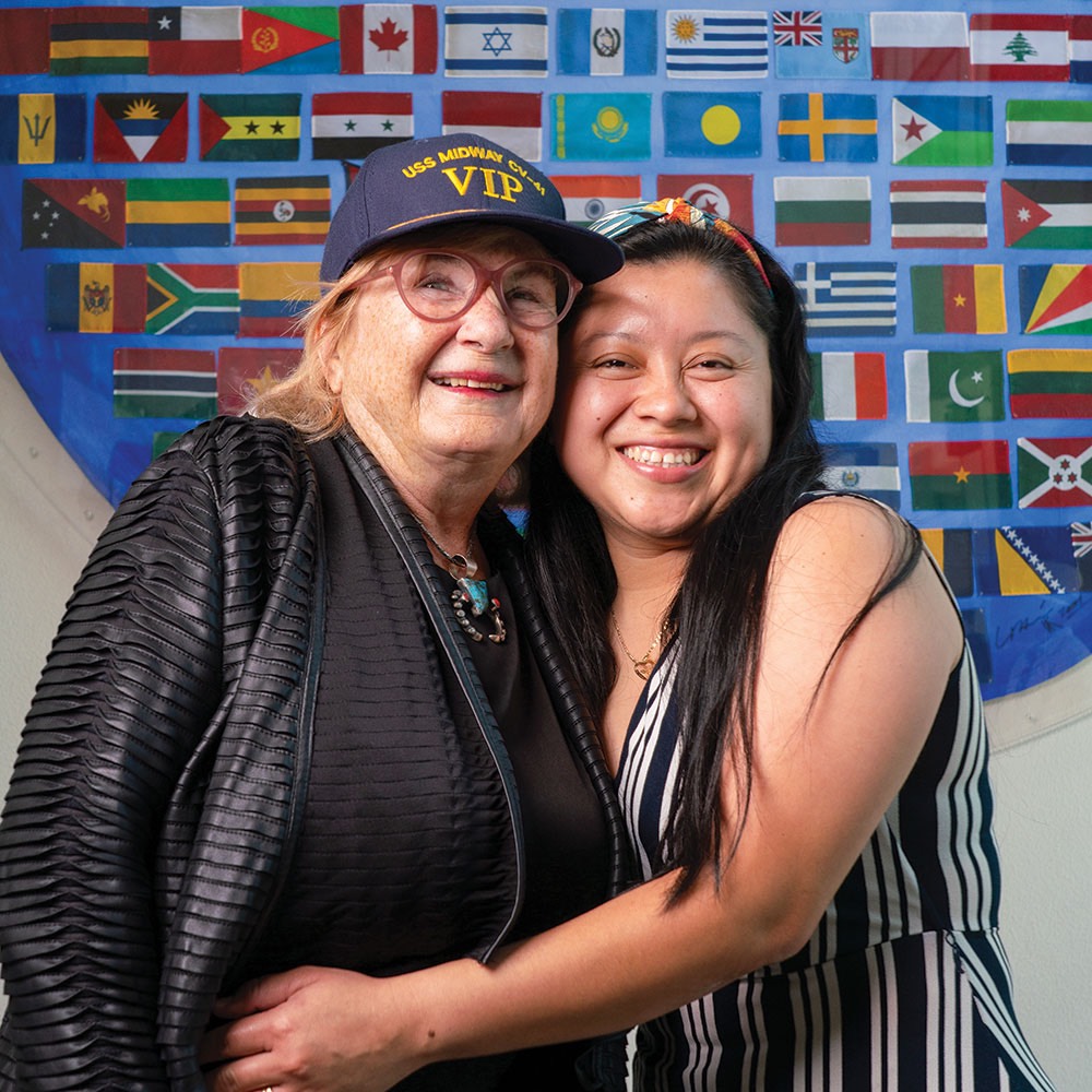 Volunteer Cheryl Brierton gets a warm hug from a student she has been supporting through her citizenship course.