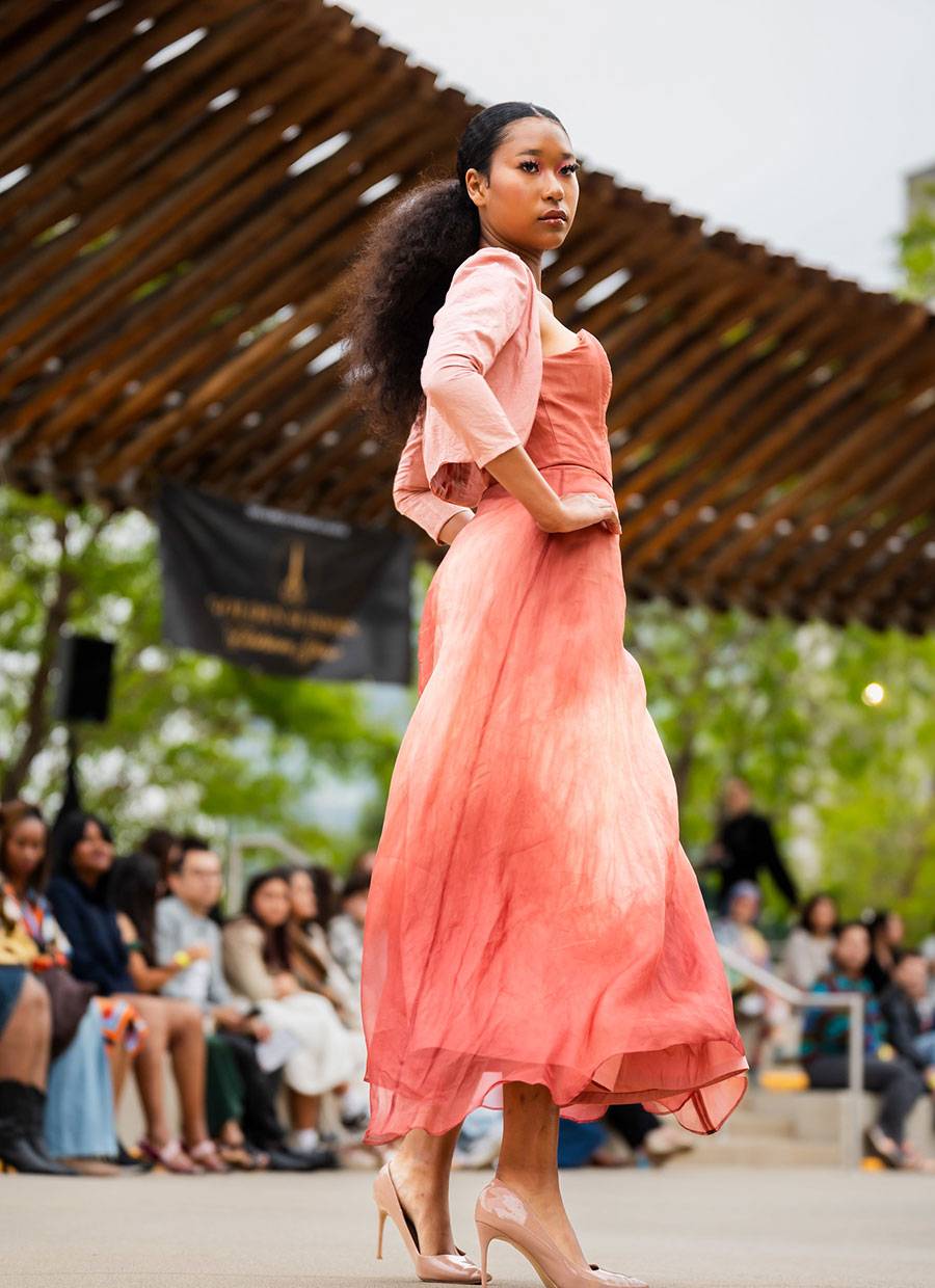 A model in an orange dress