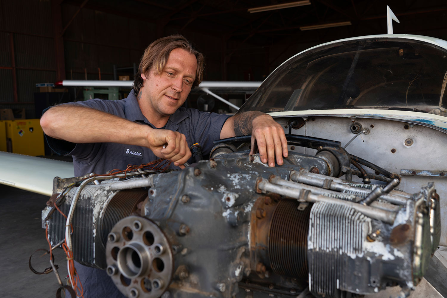 Brandon Wasliewski working on a small plane engine