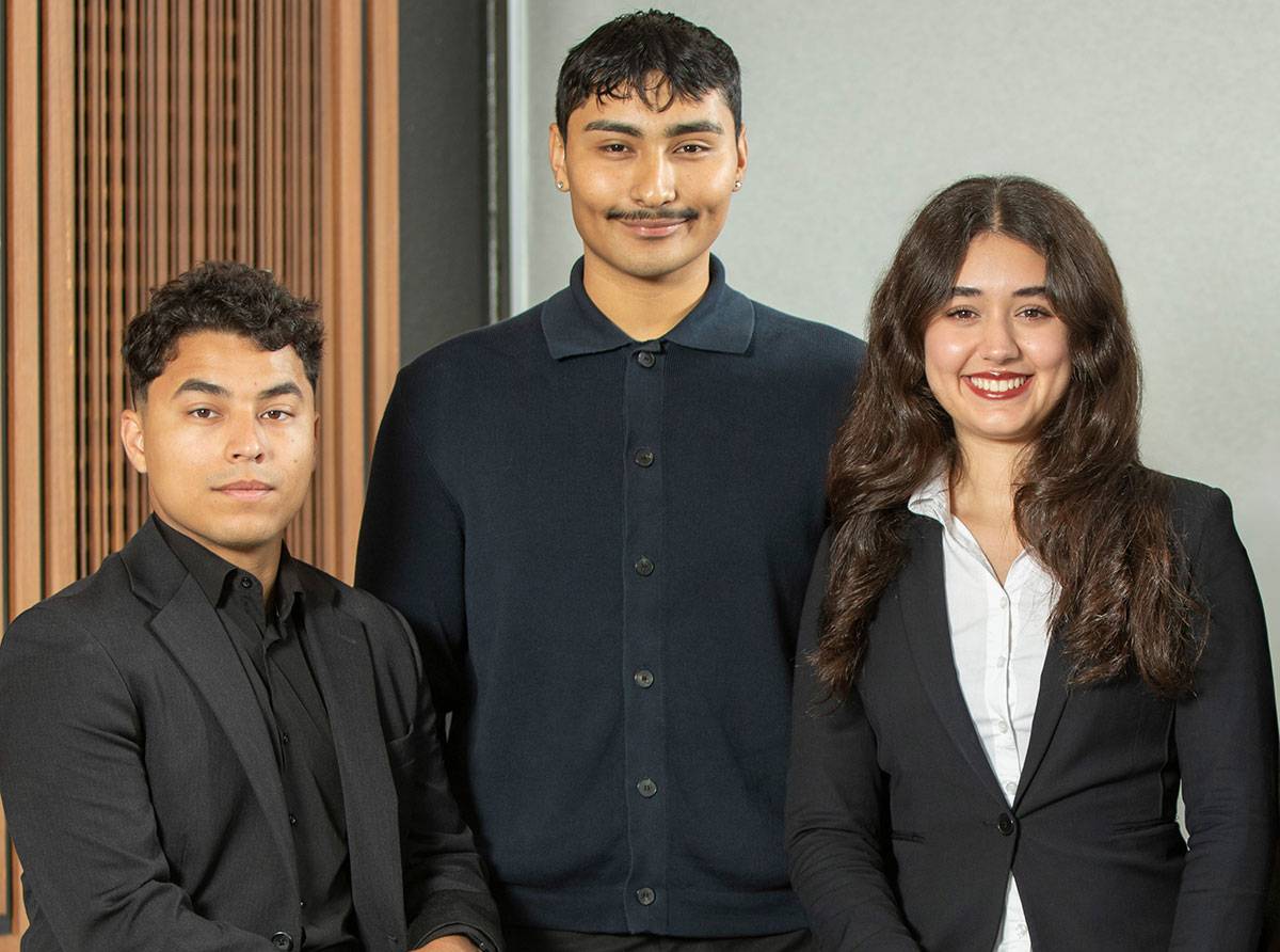 Three student trustees on the lobby of the district office