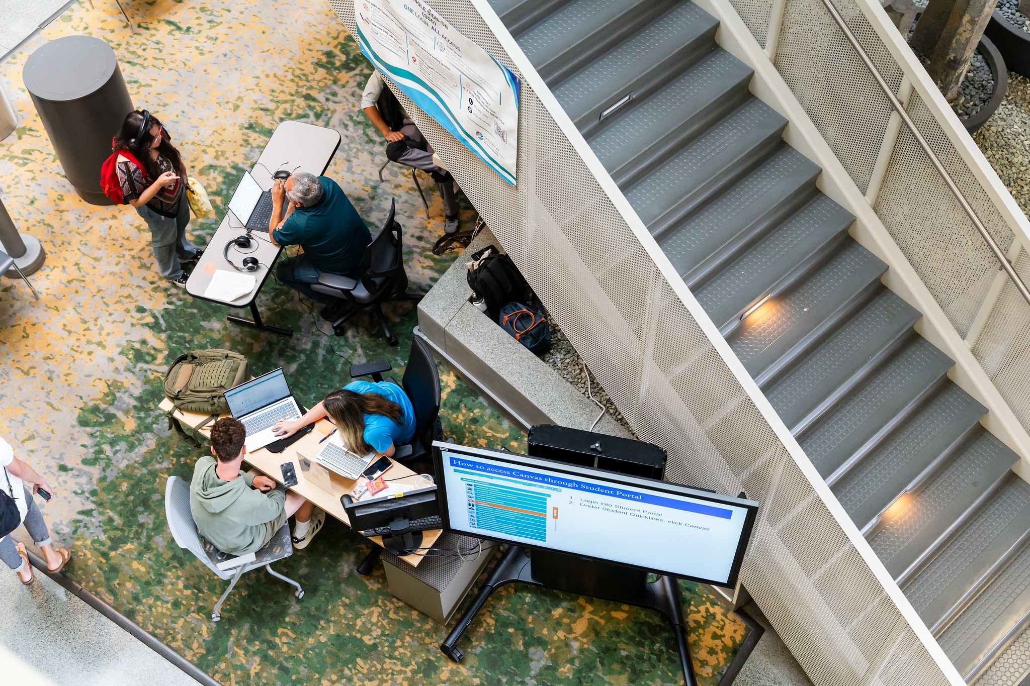 Students standing around tables in the Mesa college library
