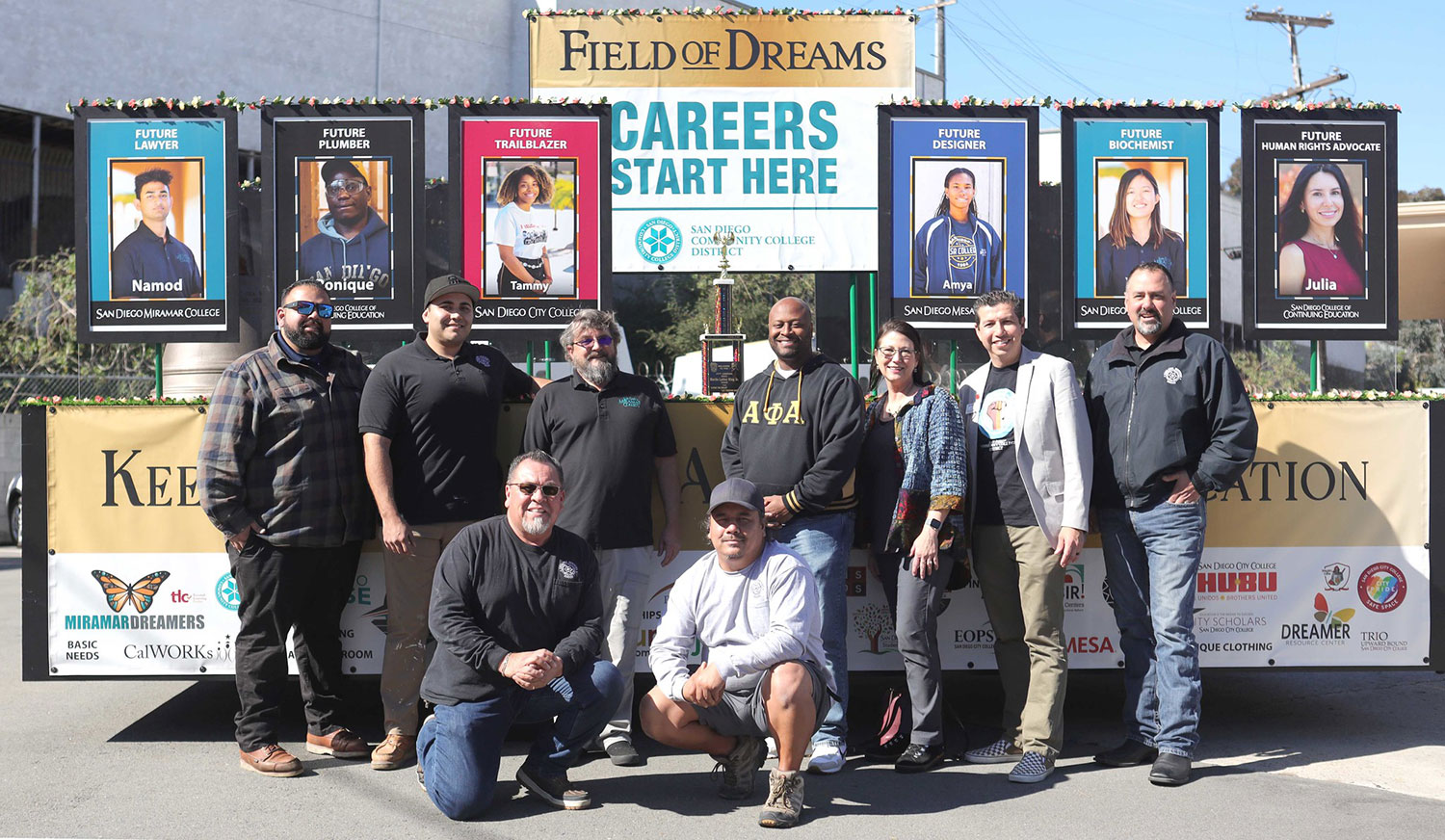 MLK Float Nine people who worked on the construction of the float take a group photo in front of the district's MLK Float. The second place trophy is on the float.